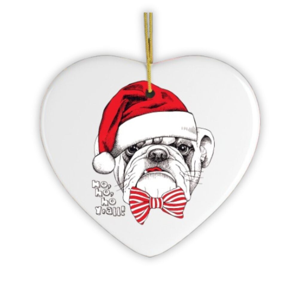 Heart-shaped ceramic ornament with a bulldog wearing a Santa hat and bow tie, on a white background.
