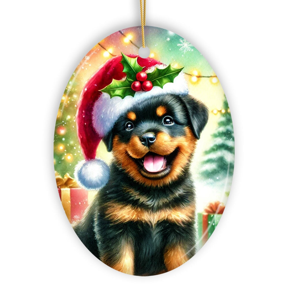 Christmas ornament with a Rottweiler puppy wearing a Santa hat and holly leaves.