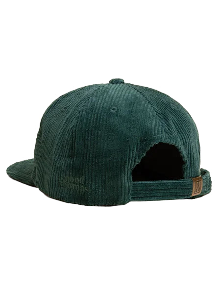 Green corduroy cap on a beige background