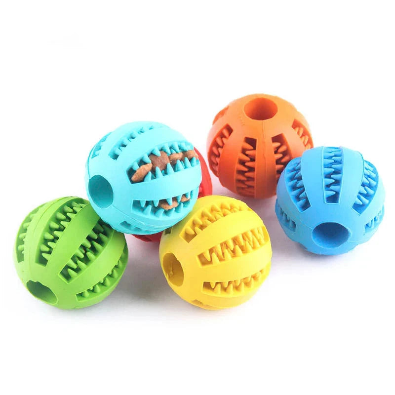 Five colorful rubber balls with zigzag grooves that support dental health. Each Interactive Elasticity Dog Ball Toy - Small Dog Chew & Tooth Cleaning Rubber Food Ball is a different color: green, blue with a brown zigzag, light blue with no inserts, yellow, and orange. The grooves can hold treats or clean teeth, appealing to your pet's natural instincts.